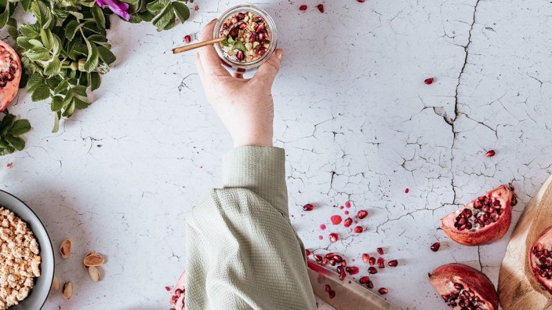 Pomegranate with yogurt, granola, and mint.
